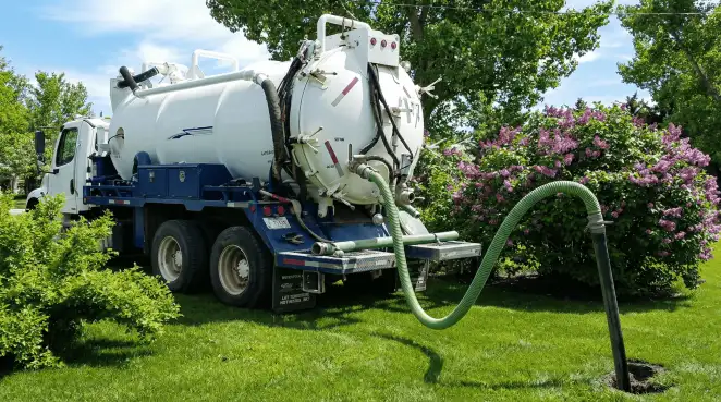 Professional vacuum truck performing residential drainage and septic maintenance in Raleigh, NC